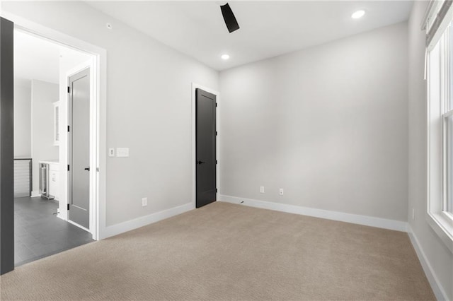 unfurnished bedroom with recessed lighting, carpet flooring, and baseboards