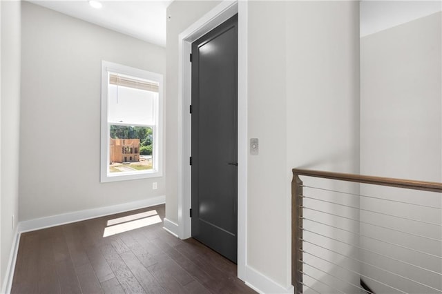 hallway featuring dark wood-style floors, recessed lighting, and baseboards