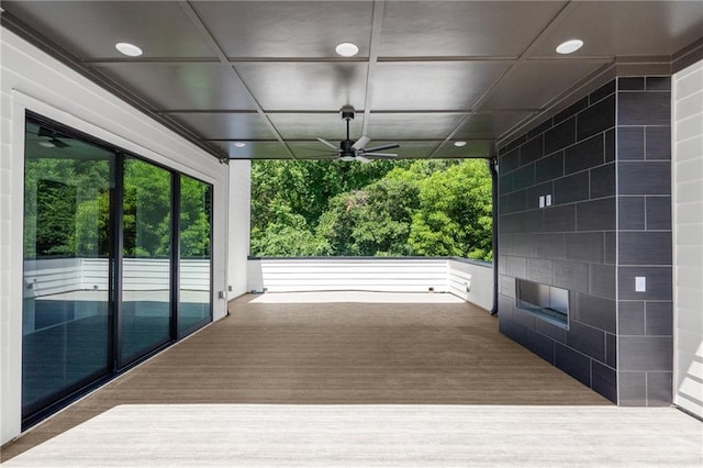 wooden deck featuring ceiling fan