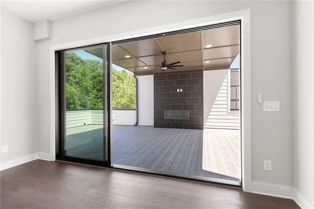 entryway with baseboards, a ceiling fan, wood finished floors, a fireplace, and recessed lighting