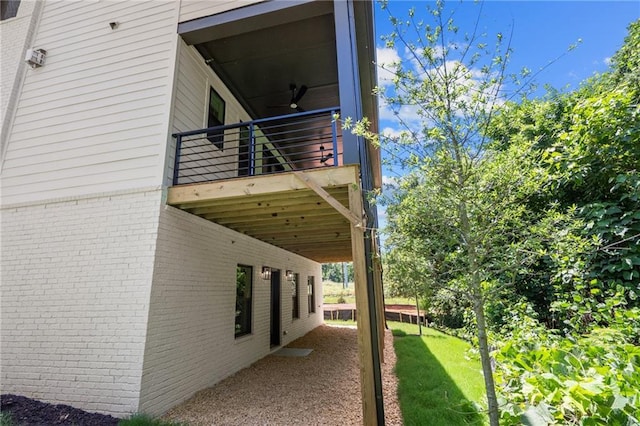 view of side of home with a yard and brick siding