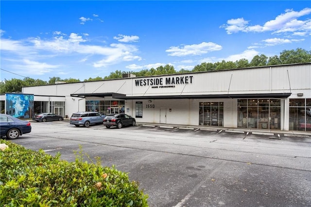 view of building exterior featuring uncovered parking