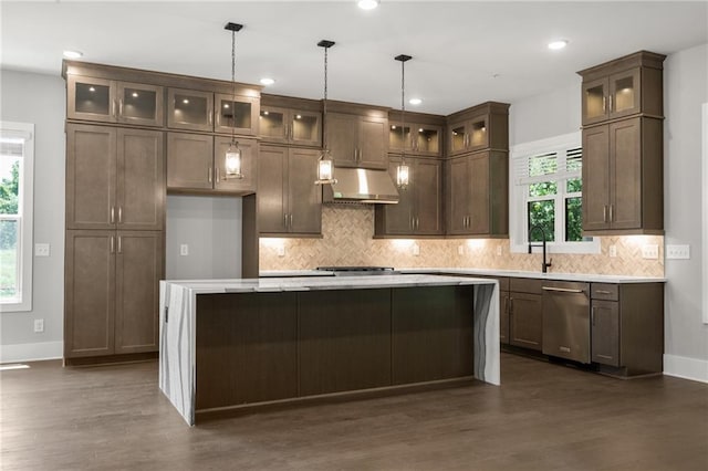 kitchen featuring dishwasher, extractor fan, dark wood finished floors, and a center island