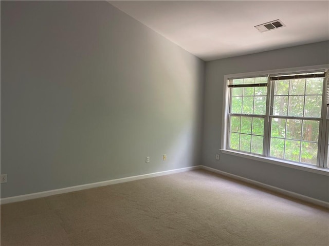 carpeted spare room with baseboards