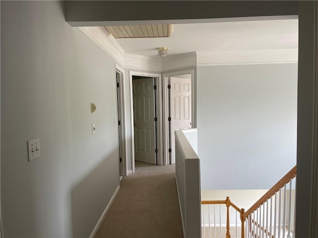 hall featuring crown molding, baseboards, light colored carpet, and an upstairs landing