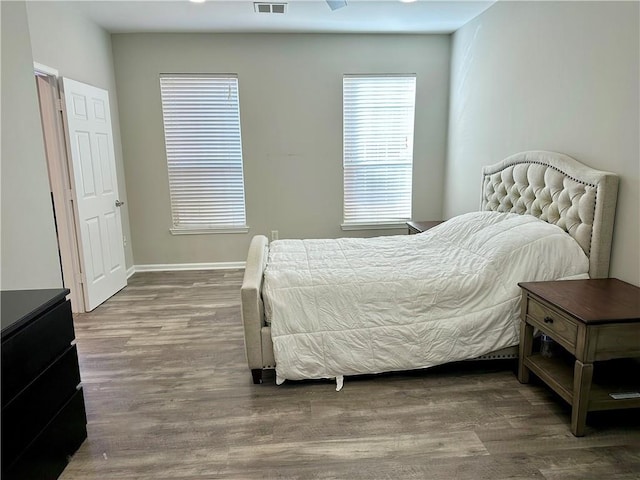 bedroom featuring wood finished floors and baseboards