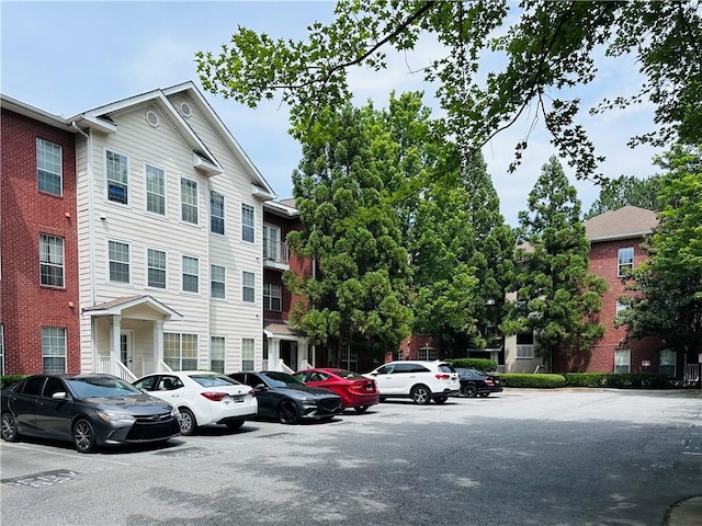 view of building exterior featuring uncovered parking