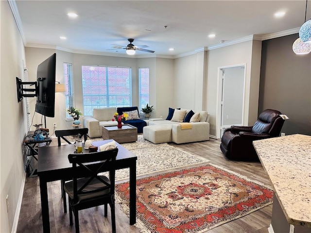 living room featuring ceiling fan, wood finished floors, recessed lighting, crown molding, and baseboards