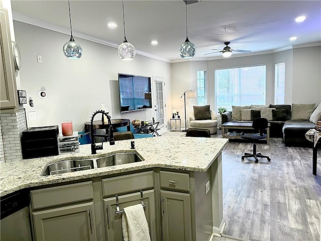 kitchen with a sink, open floor plan, ceiling fan, a peninsula, and wood finished floors