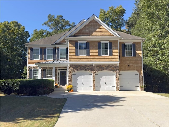 view of front of home featuring an attached garage, stone siding, and concrete driveway