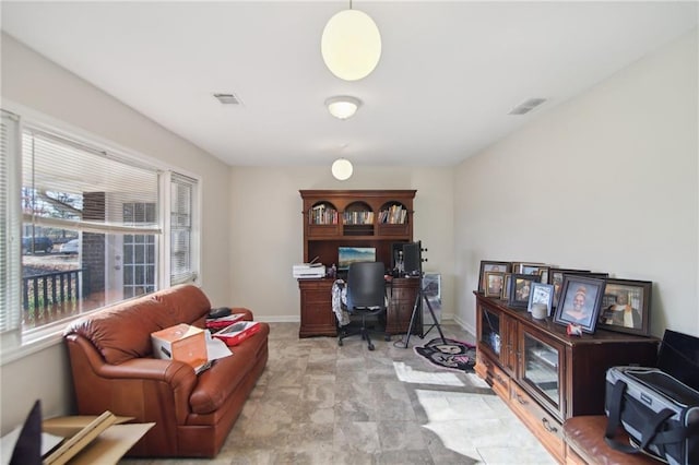 office with baseboards and visible vents