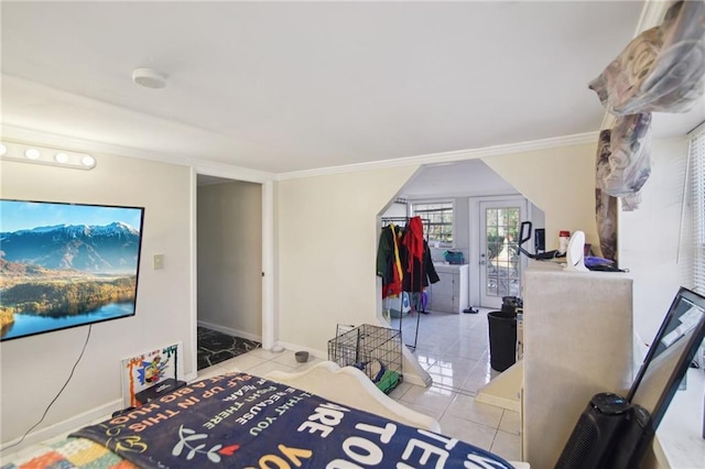 tiled bedroom with crown molding and baseboards