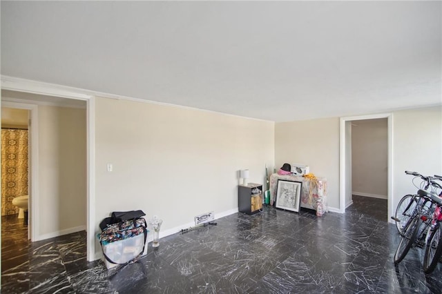 interior space with marble finish floor and baseboards