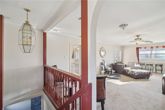 interior space with baseboards, arched walkways, and carpet flooring