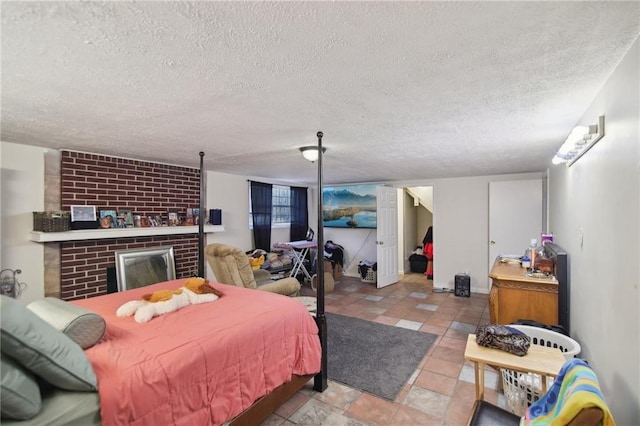 bedroom featuring a brick fireplace, baseboards, and a textured ceiling