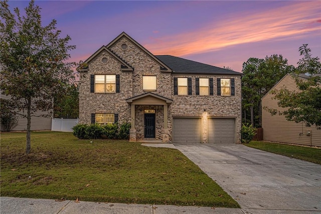 view of front of home featuring a garage and a lawn