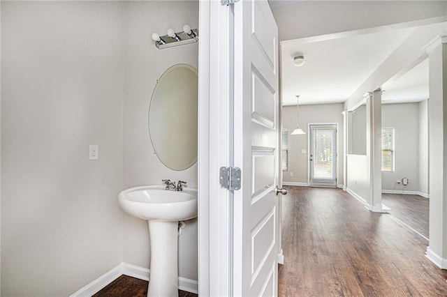 bathroom with ornate columns and wood-type flooring