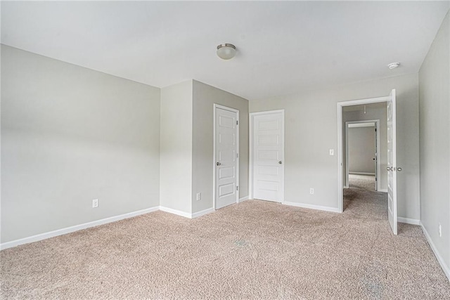 unfurnished bedroom with a closet and light carpet