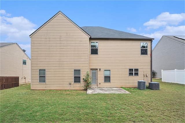 back of house featuring a lawn and a patio area