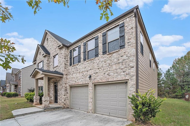 view of front of property featuring a garage and a front lawn