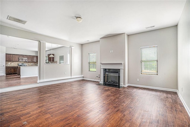 unfurnished living room featuring dark wood-type flooring