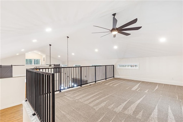 additional living space with ceiling fan, lofted ceiling, and light carpet