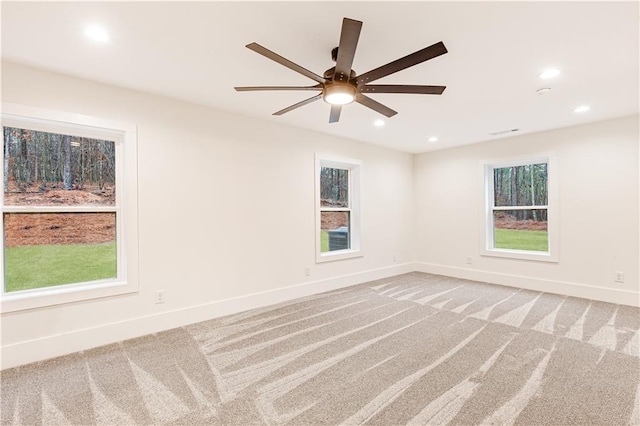 spare room with carpet and ceiling fan