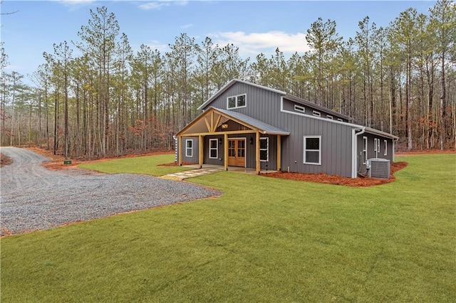 view of front of property with a porch, central air condition unit, and a front lawn