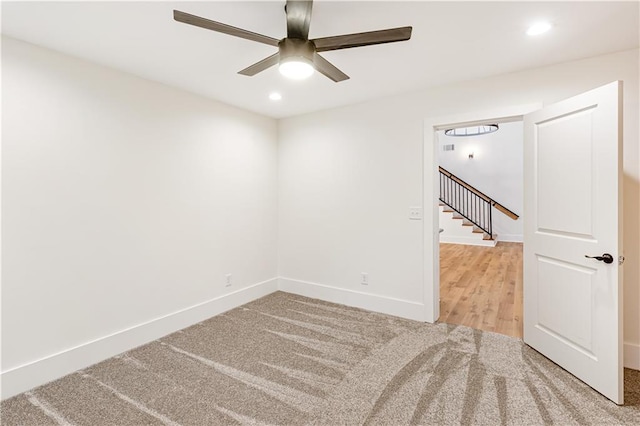 empty room with ceiling fan and carpet flooring