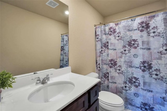 bathroom featuring vanity, a shower with shower curtain, and toilet