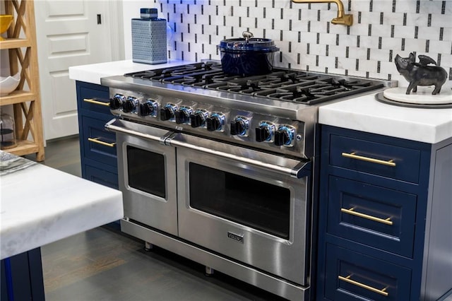 3286 Northside Pkwy NW Unit Ph2, Atlanta, GA 30327 - kitchen with blue cabinets, range with two ovens, light countertops, and dark wood-style floors