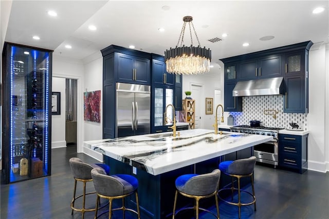 3286 Northside Pkwy NW Unit Ph2, Atlanta, GA 30327 - kitchen with high end appliances, under cabinet range hood, backsplash, a kitchen island with sink, and glass insert cabinets