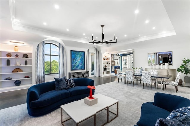3286 Northside Pkwy NW Unit Ph2, Atlanta, GA 30327 - living area with built in shelves, a chandelier, arched walkways, crown molding, and a tray ceiling
