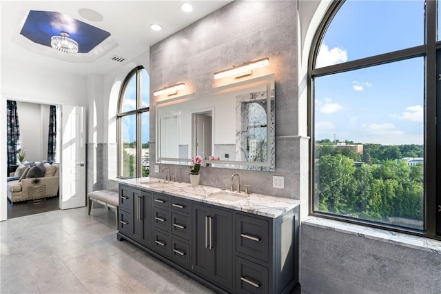 3286 Northside Pkwy NW Unit Ph2, Atlanta, GA 30327 - bathroom with double vanity, a raised ceiling, recessed lighting, tile patterned floors, and decorative backsplash