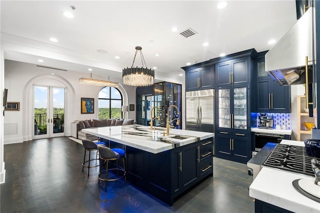 3286 Northside Pkwy NW Unit Ph2, Atlanta, GA 30327 - kitchen with range hood, french doors, open floor plan, dark wood-type flooring, and glass insert cabinets