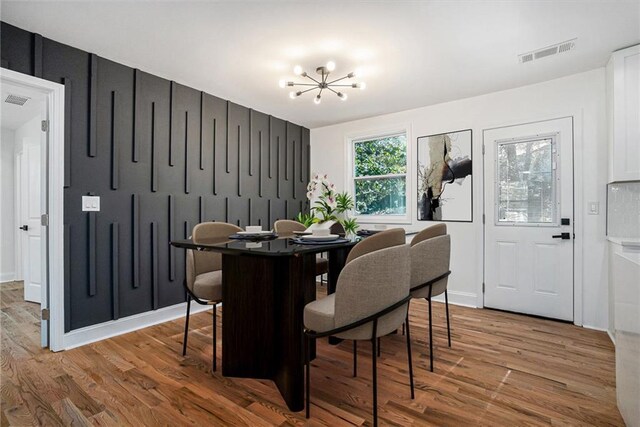 empty room featuring hardwood / wood-style flooring, a raised ceiling, and ceiling fan