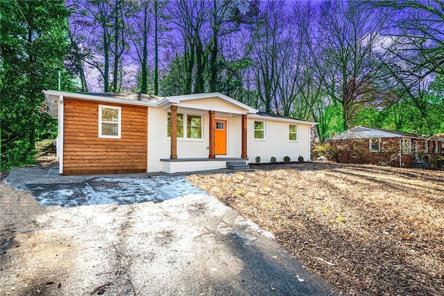 single story home featuring covered porch