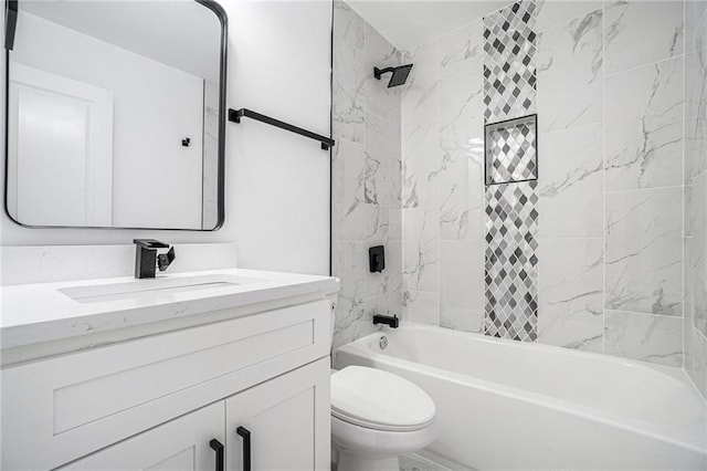 full bathroom featuring tiled shower / bath combo, vanity, and toilet