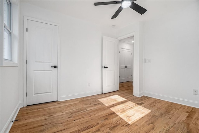 unfurnished bedroom with ceiling fan and light hardwood / wood-style floors