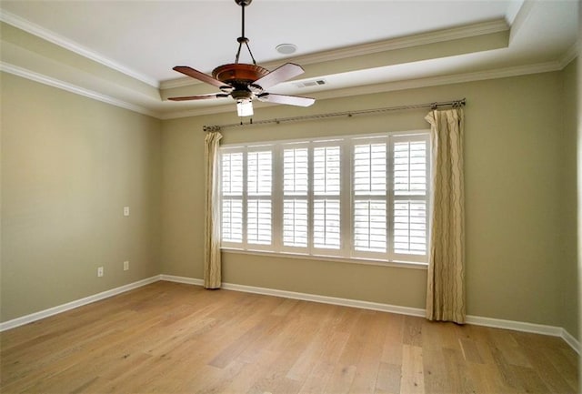 1668 Sabastian Pt NE, Atlanta, GA 30329 - unfurnished room with a tray ceiling, healthy amount of natural light, a ceiling fan, wood finished floors, and ornamental molding