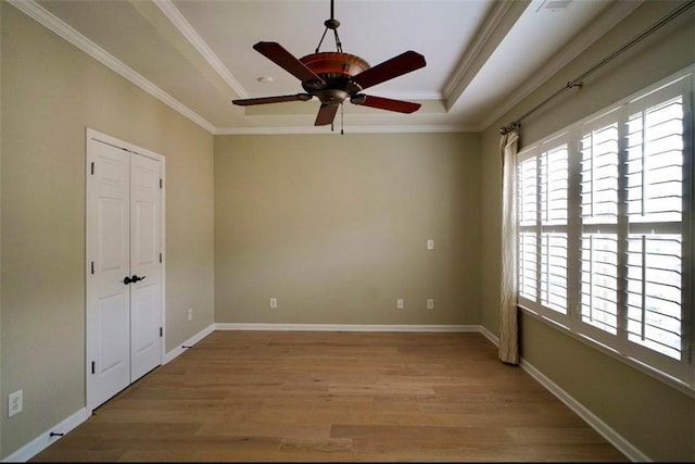1668 Sabastian Pt NE, Atlanta, GA 30329 - unfurnished room with wood finished floors, a ceiling fan, a tray ceiling, and ornamental molding