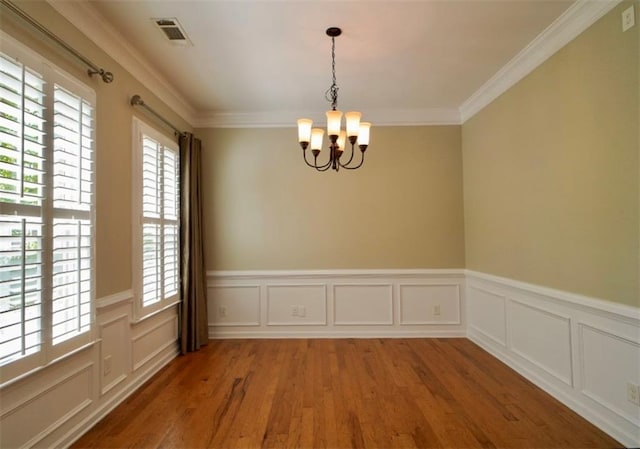 1668 Sabastian Pt NE, Atlanta, GA 30329 - spare room with a chandelier, healthy amount of natural light, light wood-style flooring, a wainscoted wall, and ornamental molding