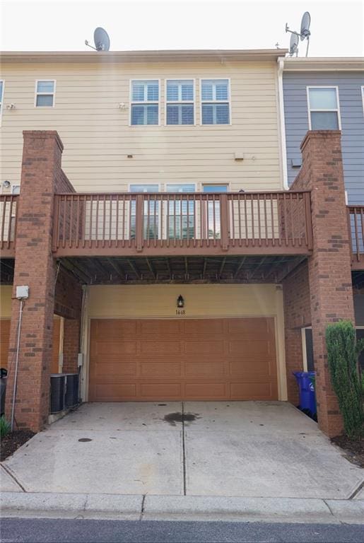 1668 Sabastian Pt NE, Atlanta, GA 30329 - rear view of property with an attached garage, a balcony, and concrete driveway
