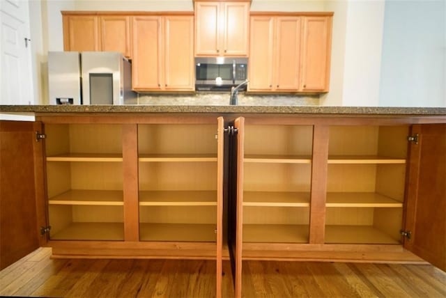 1668 Sabastian Pt NE, Atlanta, GA 30329 - kitchen featuring stainless steel microwave, fridge with ice dispenser, wood finished floors, and stone counters