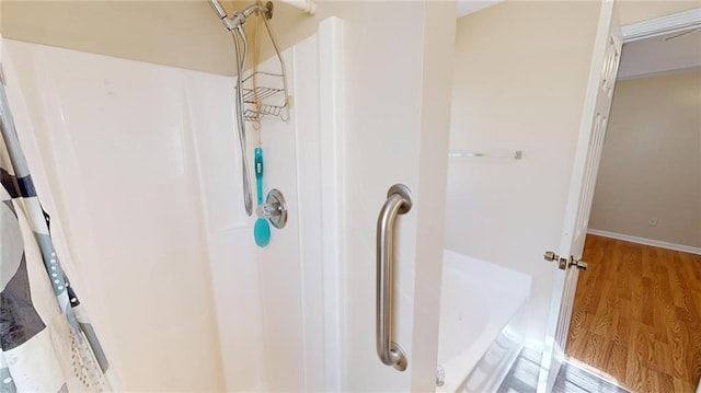 bathroom with a shower and hardwood / wood-style floors