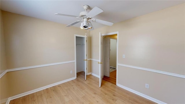 unfurnished bedroom with ceiling fan, light hardwood / wood-style floors, and a closet