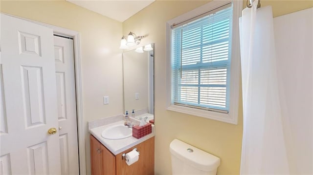 bathroom featuring toilet and vanity