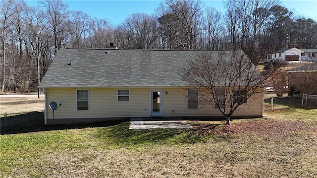 rear view of house with a lawn and a patio