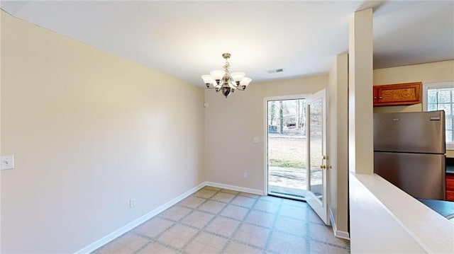 doorway with an inviting chandelier