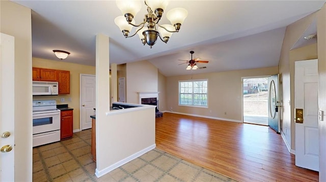 kitchen featuring hardwood / wood-style flooring, white appliances, and ceiling fan with notable chandelier